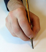 Holding a pen holder in the the closed, upright position.